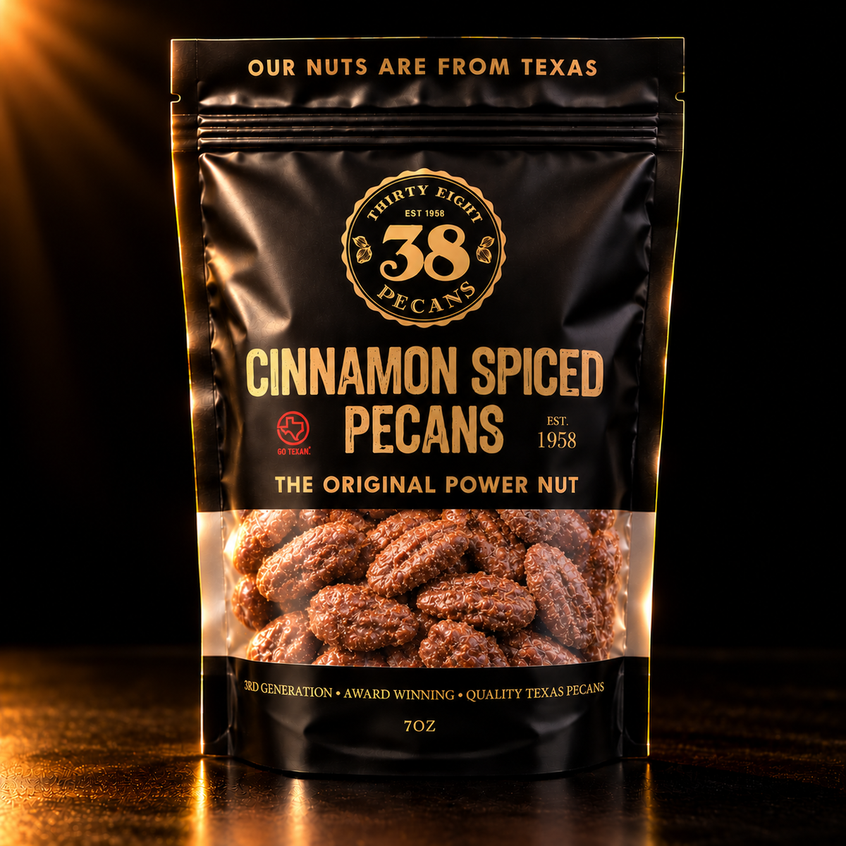 38 Pecans Cinnamon Spiced Pecans in a black and gold 7 oz resealable pouch, with cinnamon-sugar glazed Texas pecan halves visible through the clear window.