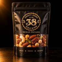 38 Pecans Deluxe Mixed Nuts in a matte black and gold resealable pouch, featuring cashews, almonds, pecans, pistachios and filberts through a clear window.