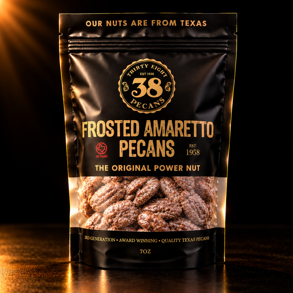 38 Pecans Frosted Amaretto Pecans in a black and gold 7 oz resealable pouch, featuring Texas pecan halves coated in sweet amaretto and powdered sugar.