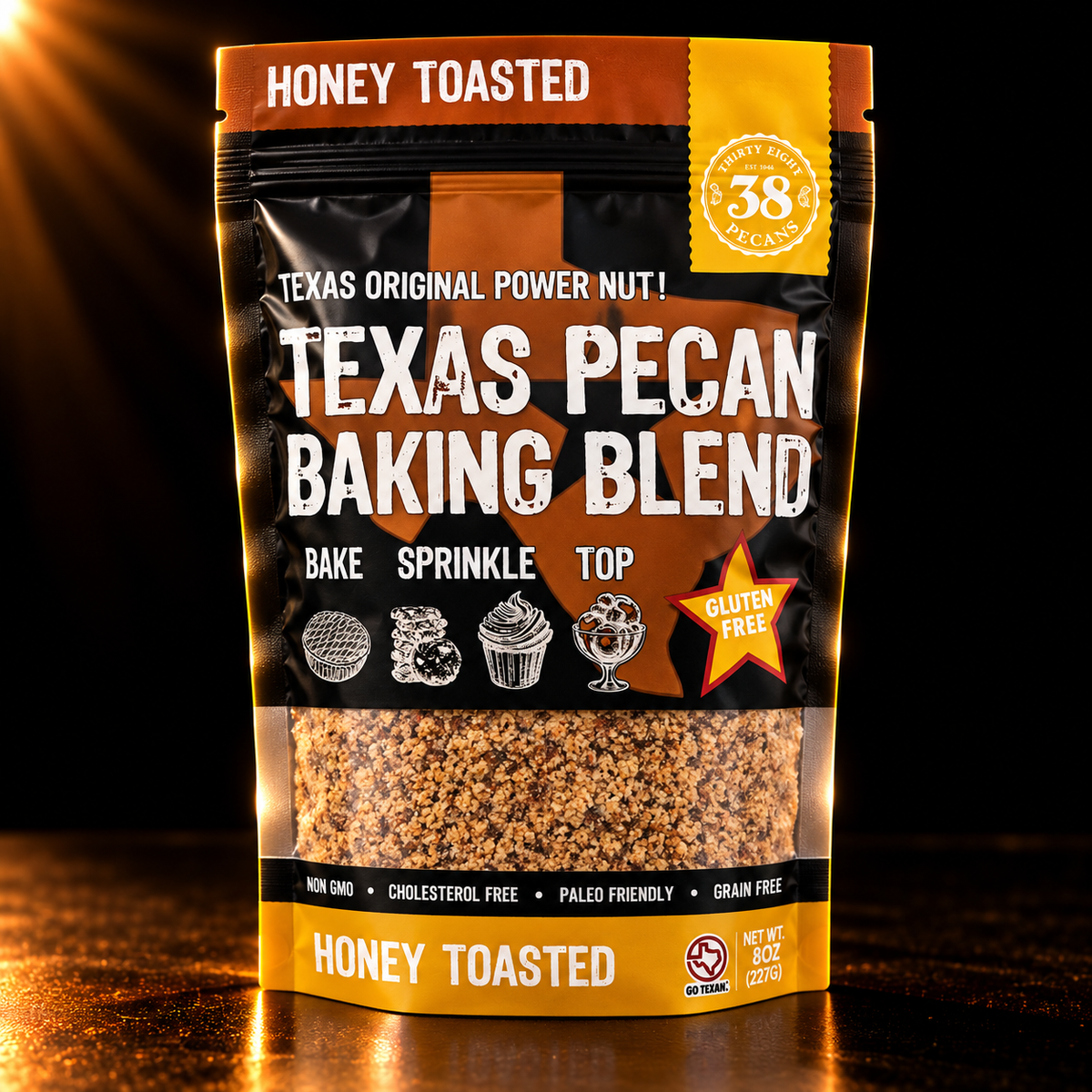 38 Pecans Honey Toasted Texas Pecan Baking Blend in its original black and gold 8 oz pouch, photographed against a dark background with warm golden lighting.