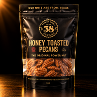 38 Pecans Honey Toasted Pecans in a black and gold 7 oz resealable pouch, with golden honey-glazed Texas pecan halves visible through the clear window.