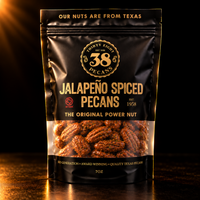 38 Pecans Jalapeño Spiced Pecans in a black and gold 7 oz resealable pouch, with savory jalapeño-seasoned Texas pecan halves visible through the clear window.