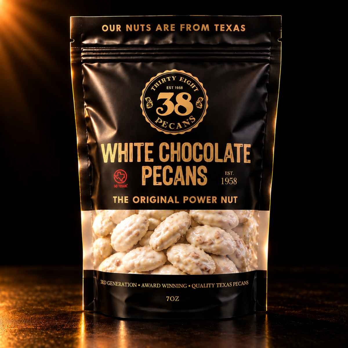 38 Pecans White Chocolate Pecans in a black and gold 7 oz resealable pouch, with creamy white chocolate-covered Texas pecan halves visible through the clear window.